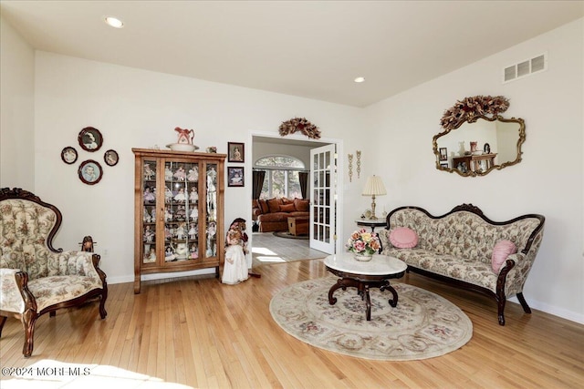 living area with hardwood / wood-style flooring