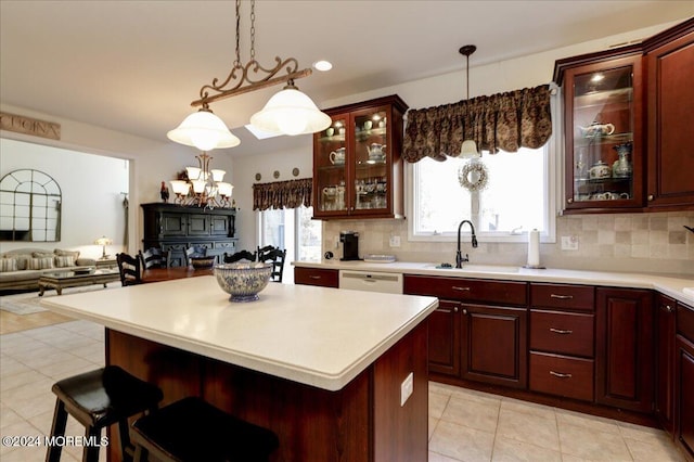 kitchen with a center island, a breakfast bar area, sink, and backsplash