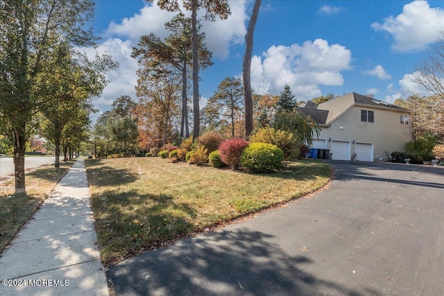 exterior space with a garage and a yard