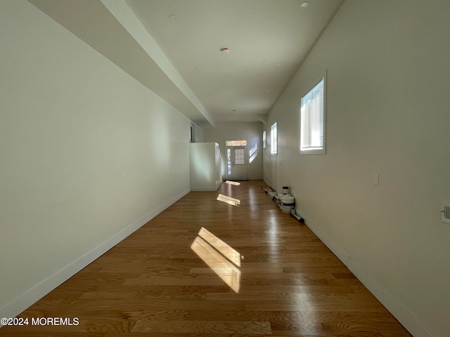 corridor with hardwood / wood-style flooring