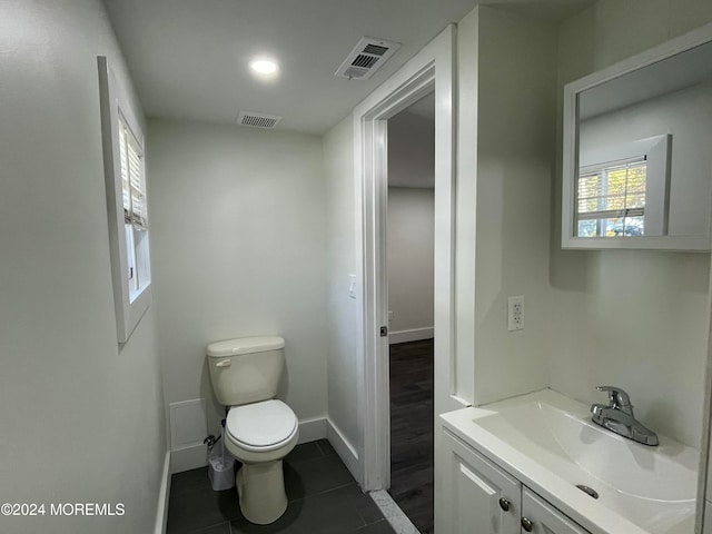 bathroom with vanity, toilet, and tile patterned flooring