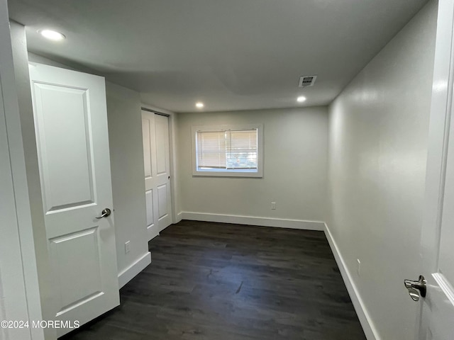 unfurnished room featuring dark wood-type flooring