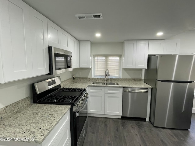 kitchen with sink, white cabinetry, dark wood-type flooring, and stainless steel appliances