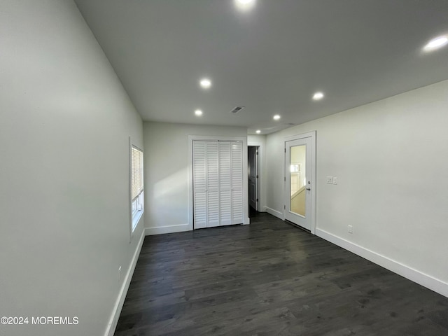 unfurnished room with dark hardwood / wood-style flooring