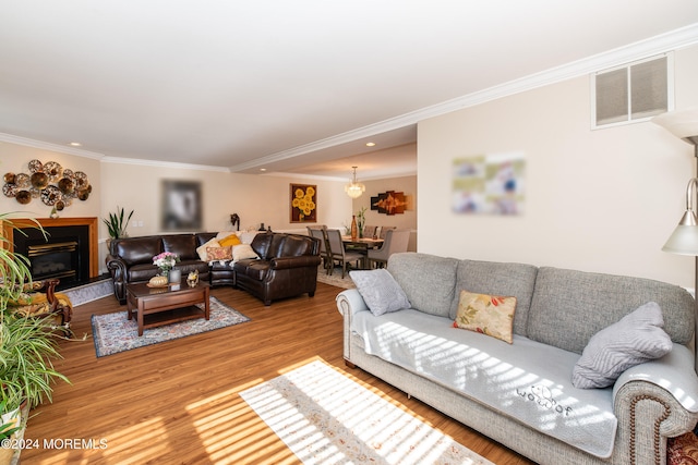 living room with wood-type flooring and ornamental molding