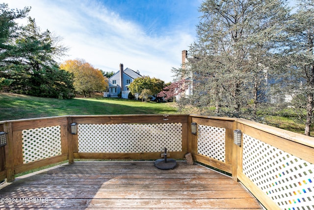 wooden terrace featuring a yard