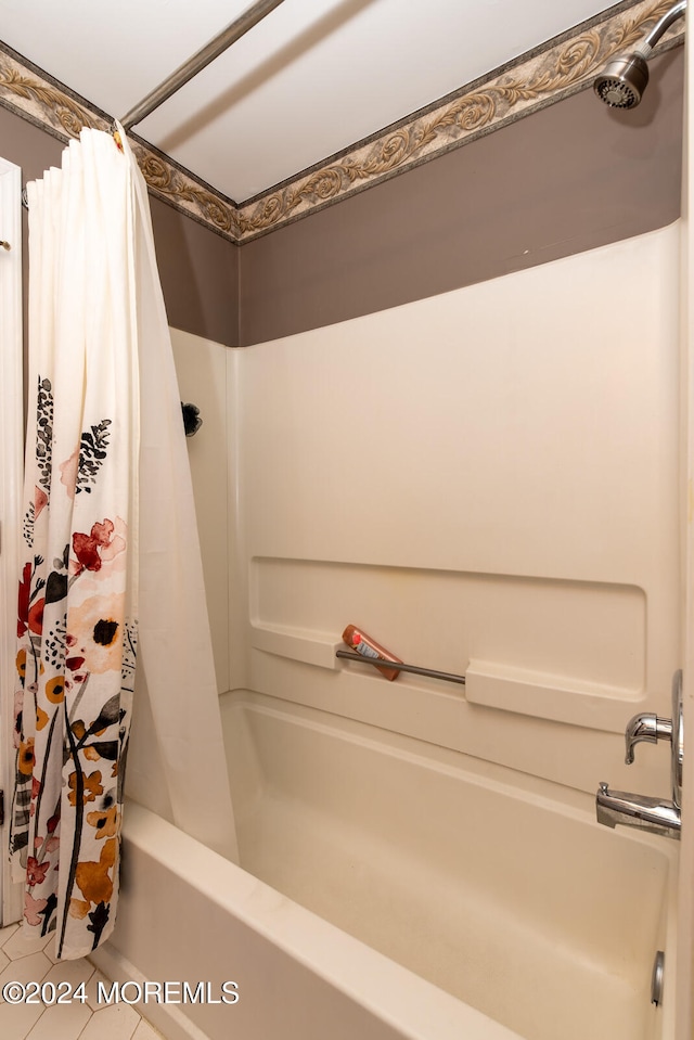 bathroom with shower / bath combo with shower curtain and tile patterned flooring