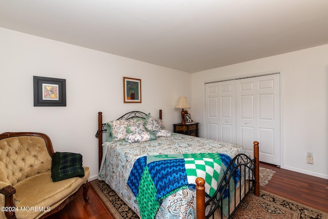 bedroom with a closet and dark hardwood / wood-style flooring