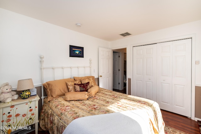 bedroom featuring a closet and dark hardwood / wood-style flooring