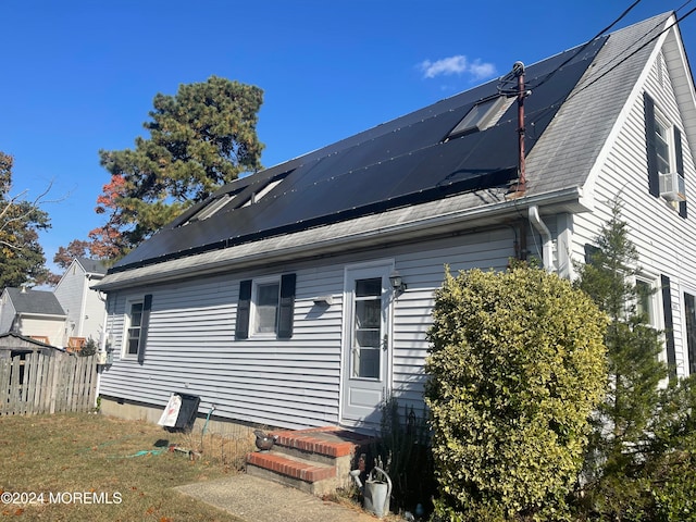 view of side of home with solar panels