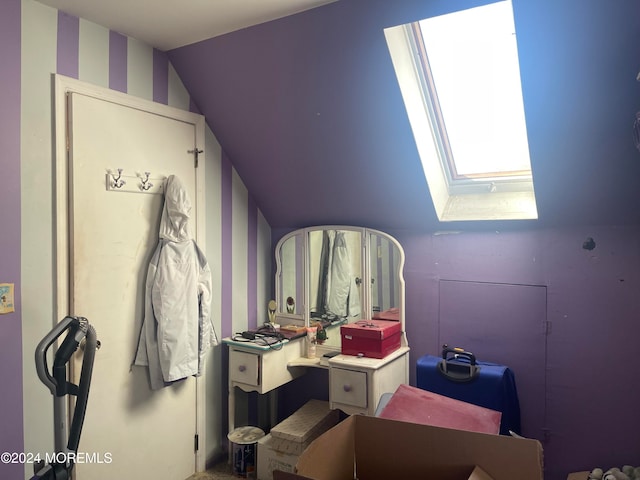 bathroom featuring lofted ceiling with skylight