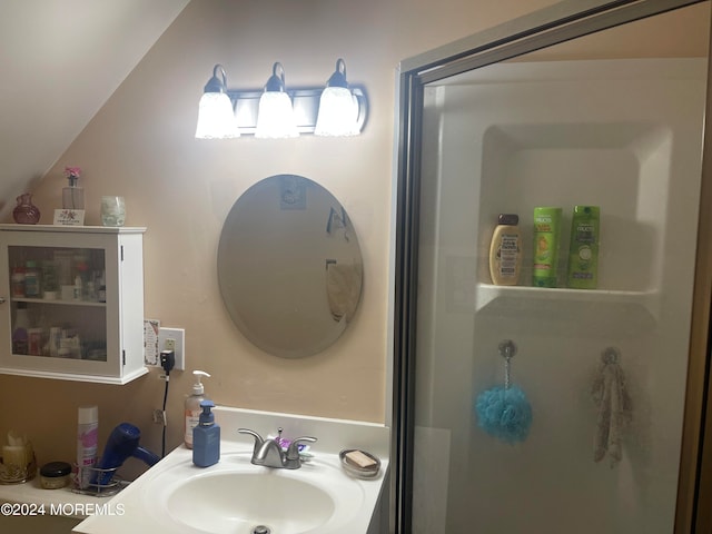 bathroom featuring sink and vaulted ceiling