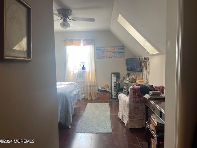 bedroom featuring ceiling fan, dark hardwood / wood-style floors, and lofted ceiling with skylight