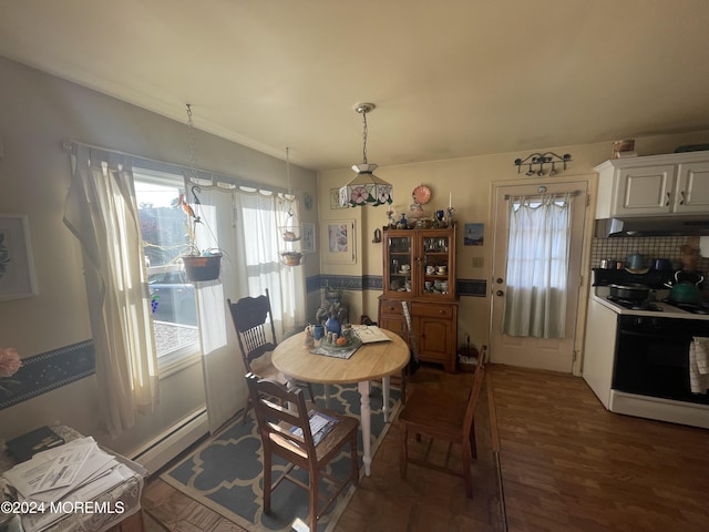 dining space featuring dark wood-type flooring and a baseboard radiator