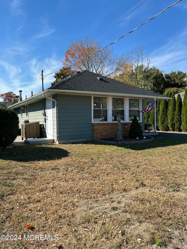 view of side of home with a lawn