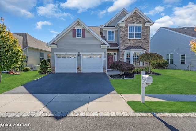 craftsman-style house featuring a front lawn and a garage