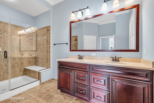 bathroom with vanity, an enclosed shower, tile patterned floors, and crown molding