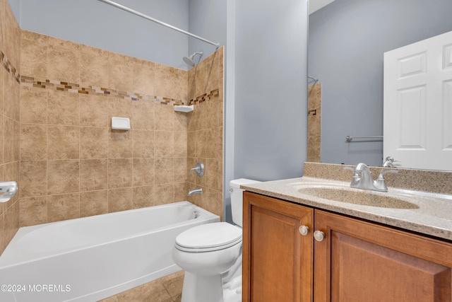 full bathroom with vanity, tiled shower / bath combo, toilet, and tile patterned floors