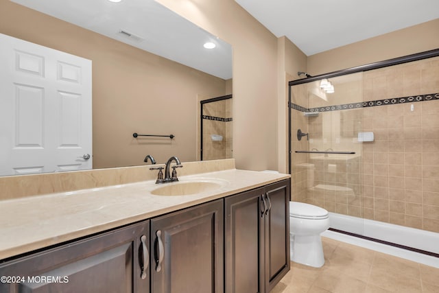 bathroom featuring vanity, tile patterned floors, toilet, and walk in shower