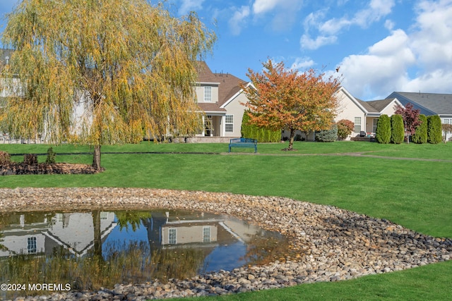 exterior space featuring a yard and a water view