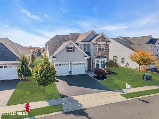 view of front of house with a front lawn and a garage