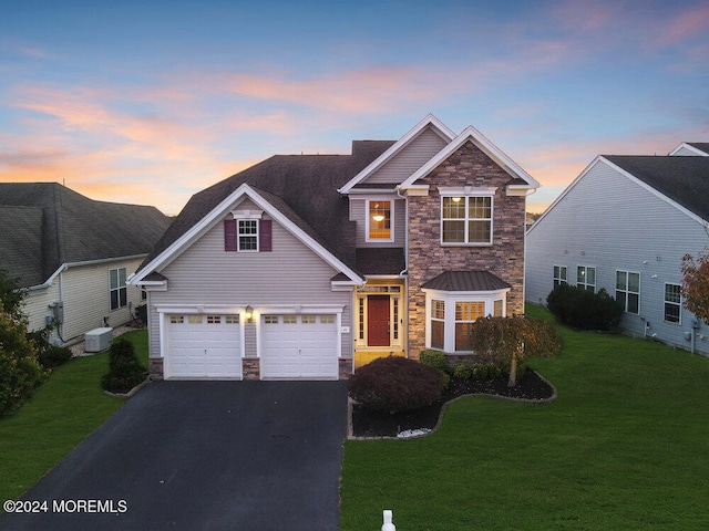 view of front of home featuring a lawn and a garage