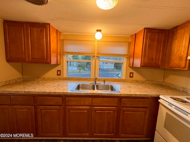 kitchen featuring sink, a textured ceiling, and white electric range