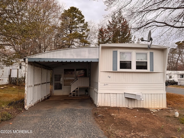 exterior space featuring a carport and aphalt driveway