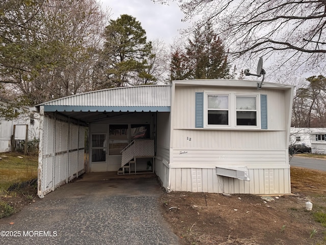 exterior space with an attached carport and driveway