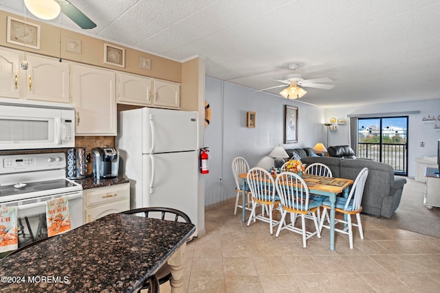 kitchen featuring ceiling fan, a textured ceiling, light tile patterned floors, white appliances, and white cabinets