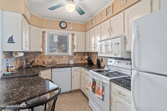 kitchen with white cabinetry, decorative backsplash, light tile patterned floors, and white appliances