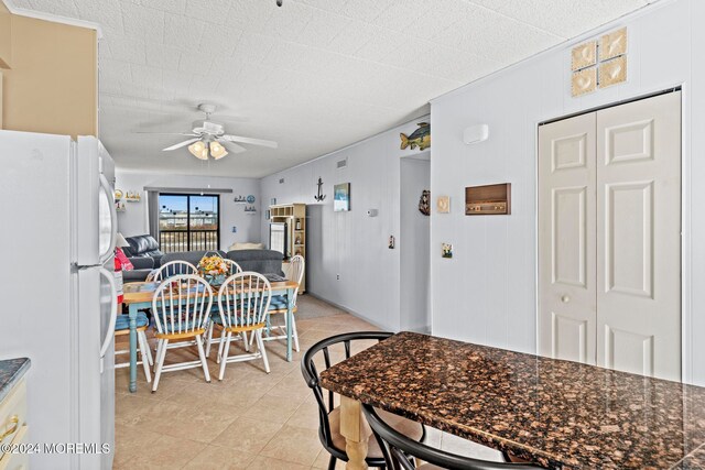 tiled dining area featuring ceiling fan