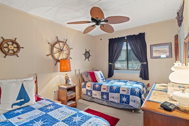 bedroom featuring ceiling fan and carpet