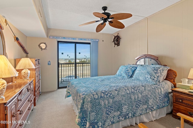 carpeted bedroom with a textured ceiling, access to outside, and ceiling fan