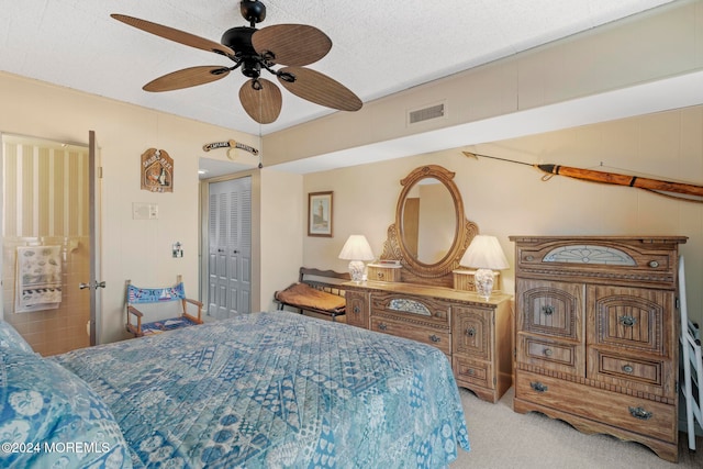 bedroom with a closet, a textured ceiling, light carpet, and ceiling fan