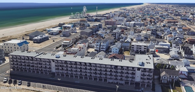 drone / aerial view featuring a view of the beach and a water view