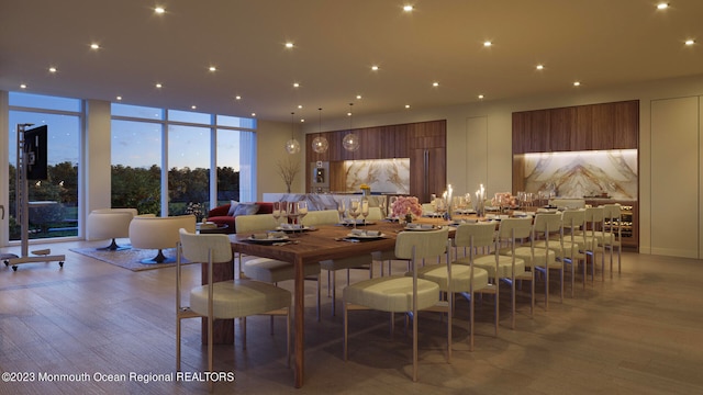 dining area featuring light wood-type flooring and floor to ceiling windows