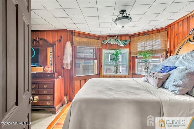 bedroom with wooden walls