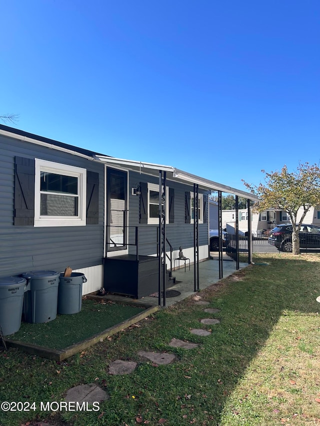 view of front of house with a patio area and a front yard