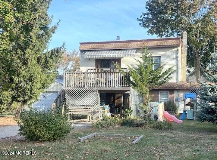 rear view of property with a wooden deck