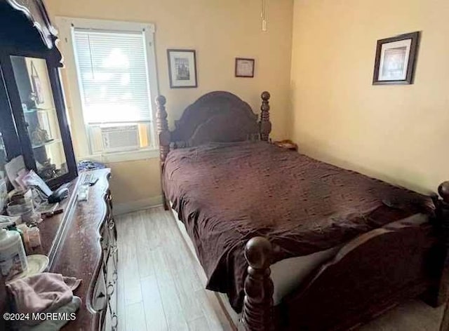 bedroom featuring light hardwood / wood-style flooring and cooling unit