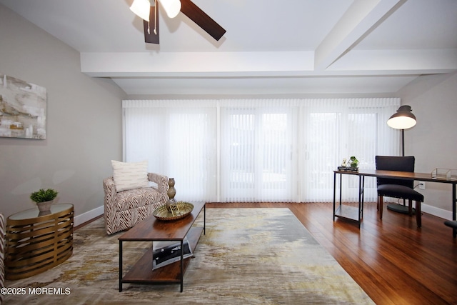 interior space with ceiling fan, wood-type flooring, and beamed ceiling