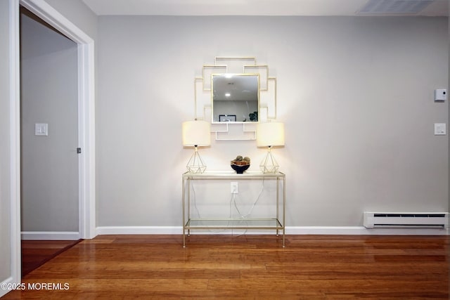 hallway with hardwood / wood-style flooring and a baseboard radiator