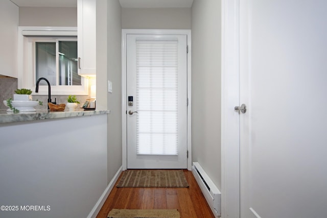 entryway featuring dark hardwood / wood-style floors and baseboard heating