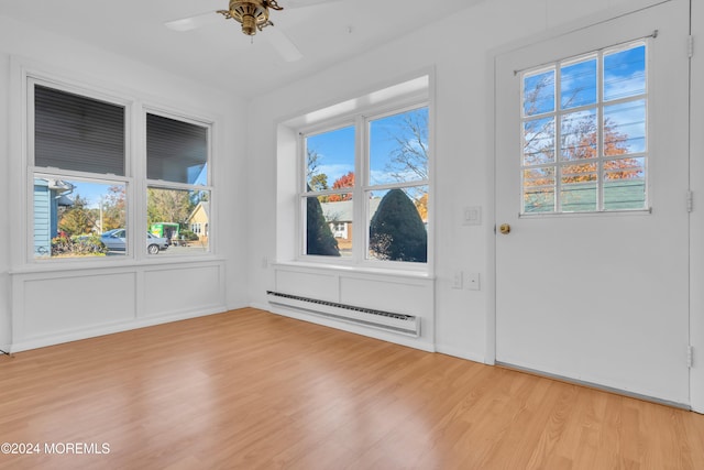 interior space featuring light hardwood / wood-style floors, baseboard heating, and ceiling fan