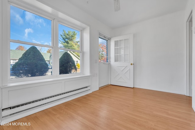 unfurnished sunroom featuring baseboard heating