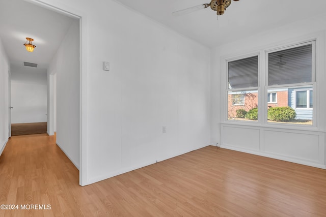 spare room featuring light hardwood / wood-style flooring and ceiling fan