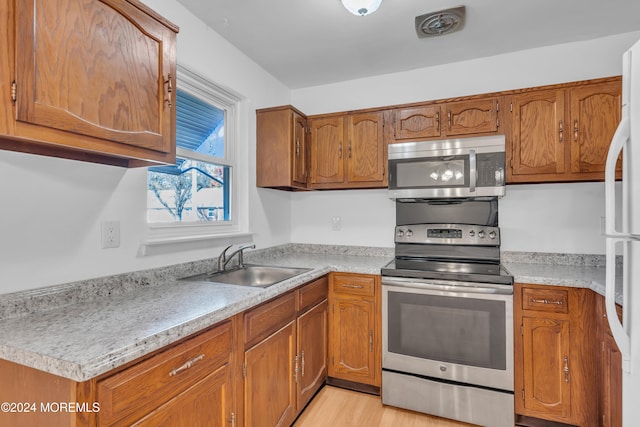 kitchen featuring light hardwood / wood-style flooring, stainless steel appliances, and sink