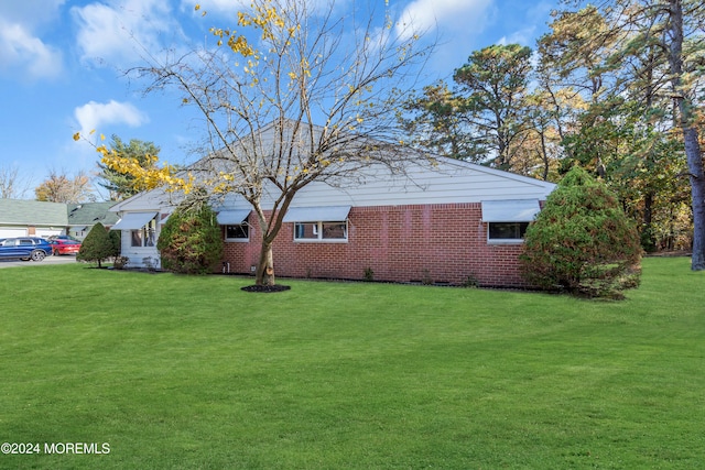 view of property exterior featuring a lawn