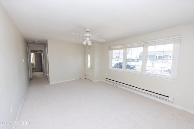 carpeted spare room with ceiling fan and baseboard heating